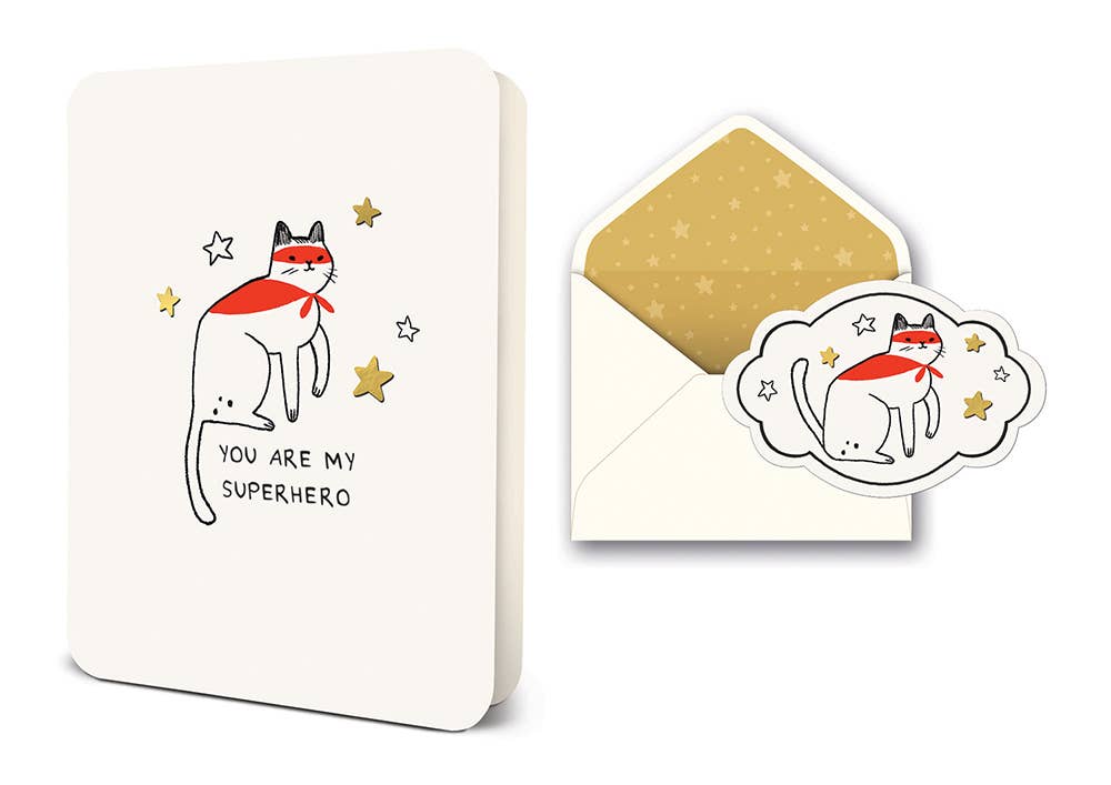Notebook with a cat illustration and 'You are my superhero' text, accompanied by an open envelope showing the same design.
