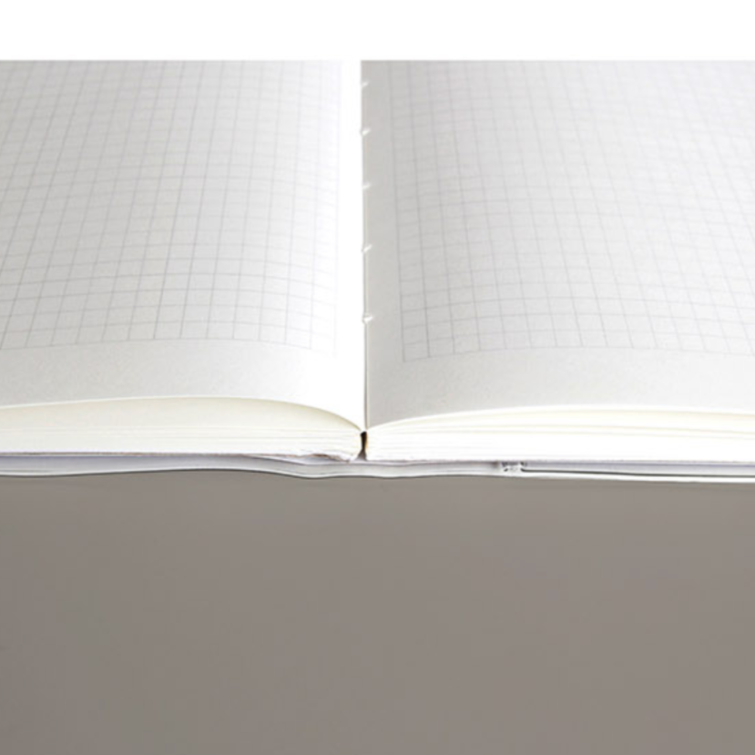 Open notebook with grid paper on a gray background