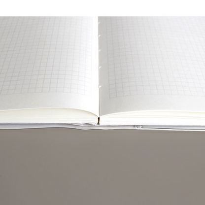 Open notebook with grid paper on a gray background