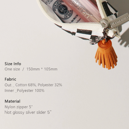 Small white bag with a tassel on a light gray background