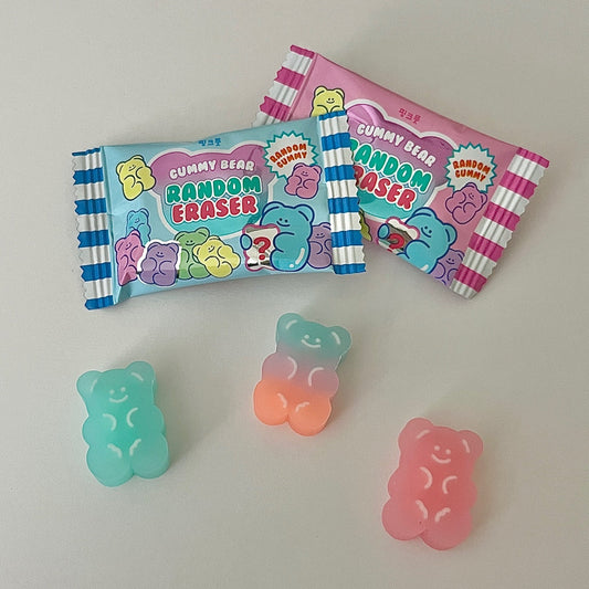 Gummy bear-shaped random erasers with packaging on a light gray background