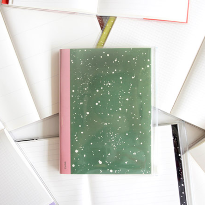 Green notebook with pink edge on a white background