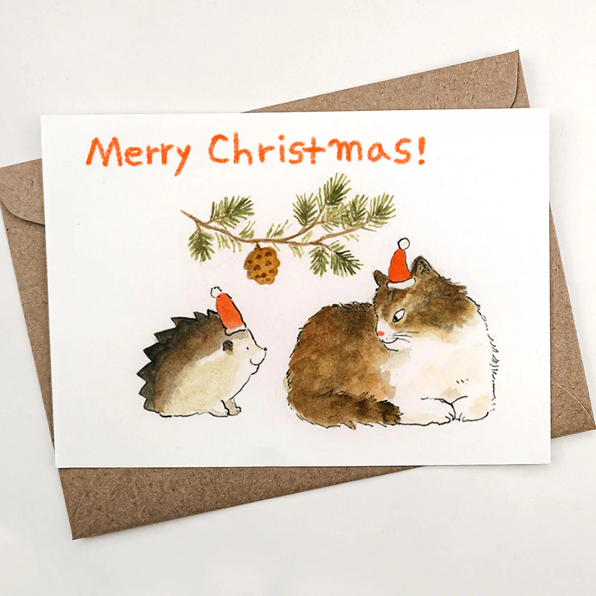 Christmas card with hedgehogs and a pine branch, featuring 'Merry Christmas!' text.