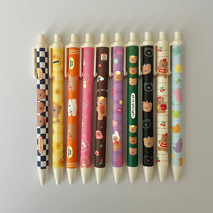 Row of colorful pens with cartoon character designs on a light gray background