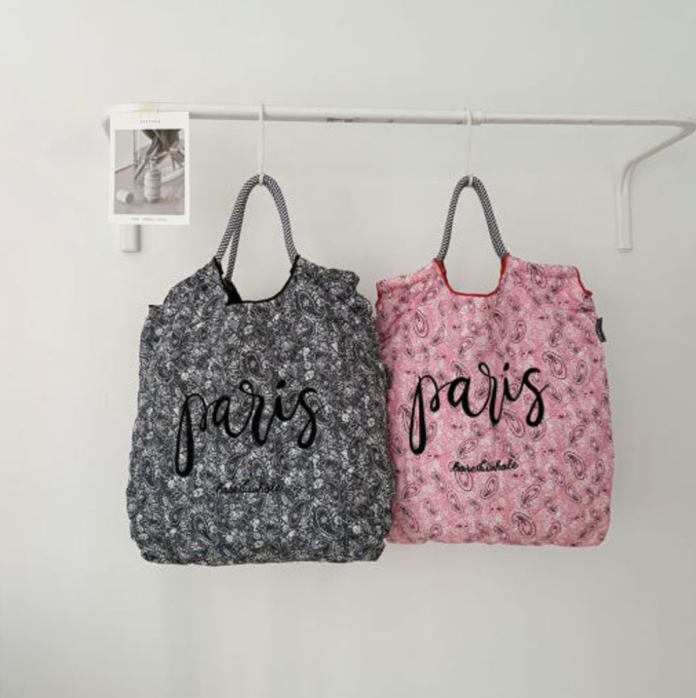 Two floral-patterned bags with 'Paris' text on a white background