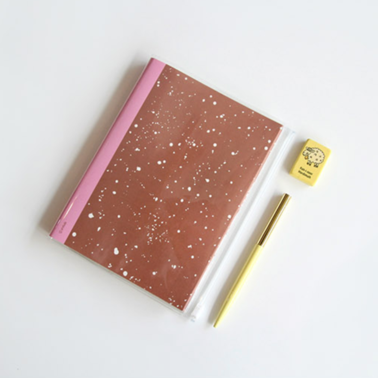 Notebook with pink cover, pen, and eraser on a white background