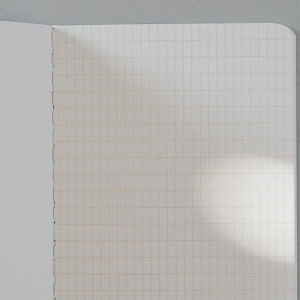 Sheet of paper with grid pattern on a gray background